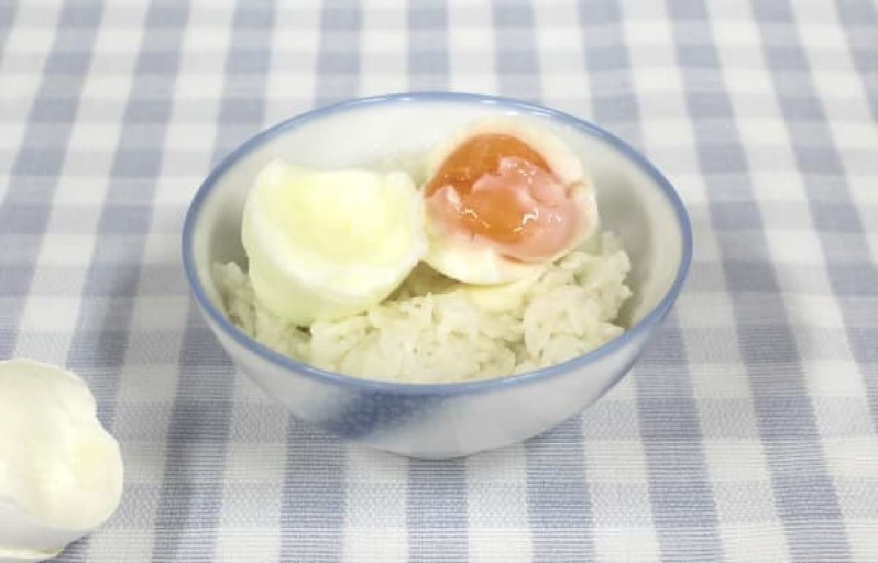 Half-lived egg with egg over rice
