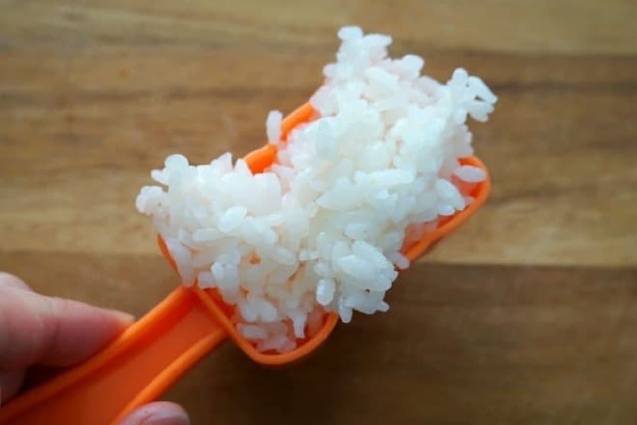 Scoop the rice with a lightly moistened mold